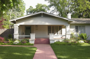 Modest craftsman style house with red brick walkway