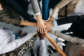 Office colleagues stacking hands