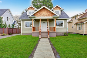 Small house exterior. View of entrance porch with stairs and walkway