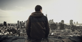 Man sitting looking over city