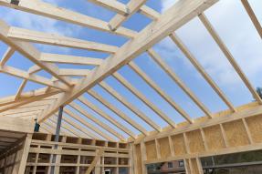 Roof framing against a blue sky