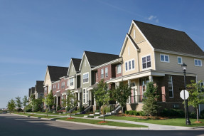 Row of suburban townhouses on a summer day