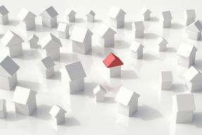 Small white wooden houses, one with a red roof