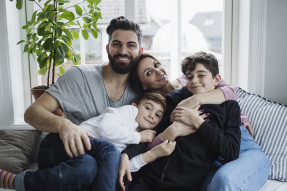 Smiling family sitting on the couch