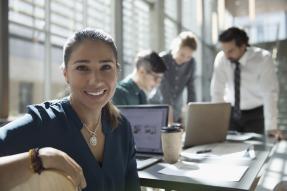 Smiling professional woman at laptop