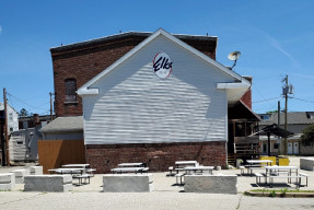 Parking lot (after image): Picnic tables and benches give community residents a place to enjoy a meal outdoors.