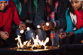 People roasting marshmallows in firepit