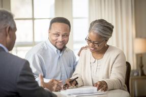 Three people reviewing a contract