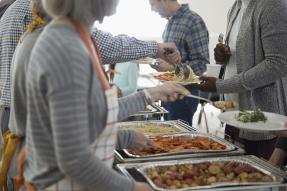 Volunteers serving food at a soup kitchen