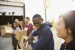 Volunteers unloading boxes from a van