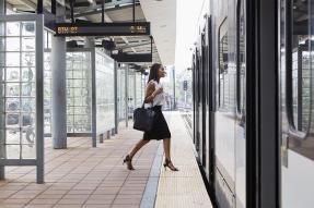 Woman boarding public transit train