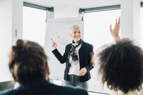 Woman giving a presentation to an office group