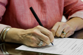 Woman signing a contract