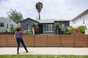 Woman taking a picture of a house