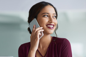 Young businesswoman using a smartphone in a modern office