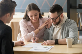 Young couple signing a contract