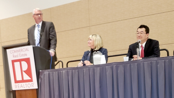 Three panelists address attendees at the Commercial Economic Issues & Trends Forum