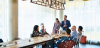 Office meeting with multi-racial colleagues in a brightly lit, open room