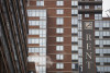 A shot of a highrise apartment building with a large rent sign