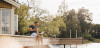 man using laptop while sitting on deck