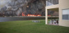 A picture of a wildfire from a distance, with large billows of smoke filling the sky.