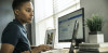 Woman working on desktop computer