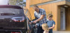 Father with children, charging electric car.