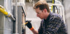 A worker repairing a furnace