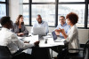 Business woman advising board members in office