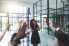 Business woman addressing audience questions with hands raised