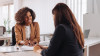 Woman agent reviewing insurance policy with client