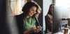 Businesswoman using smartphone at desk