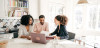 Real estate agent talking with clients in kitchen