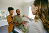 Real estate agent handing clients a key in an empty house