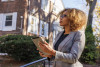 Real estate appraiser with clipboard outside a home