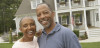 Couple in front of new home