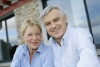 Senior couple in front of a house